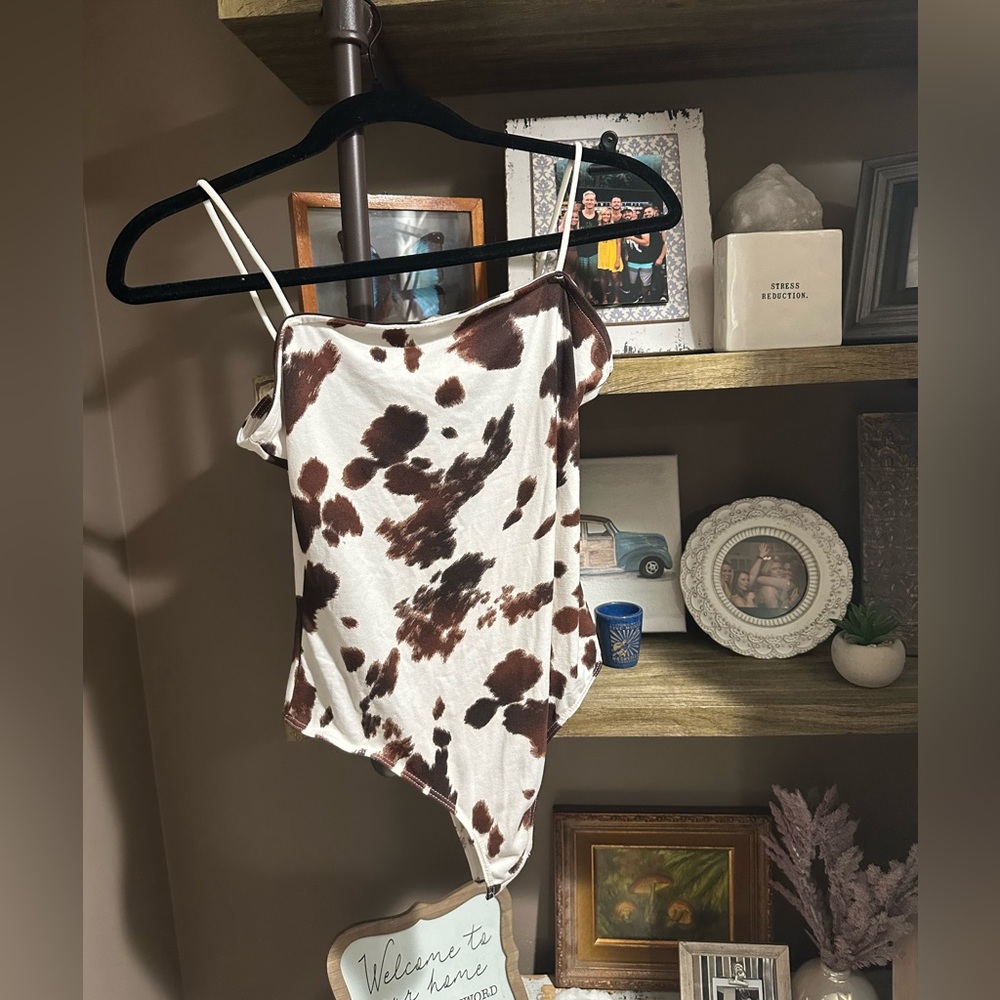 Brand new with tags cow print body suit! Size medium from forever 21!